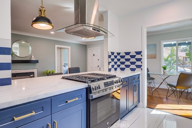 kitchen with light stone counters, blue cabinetry, tasteful backsplash, gas stove, and exhaust hood