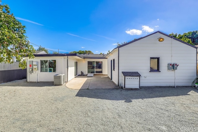 rear view of property with a patio area, fence, and central air condition unit