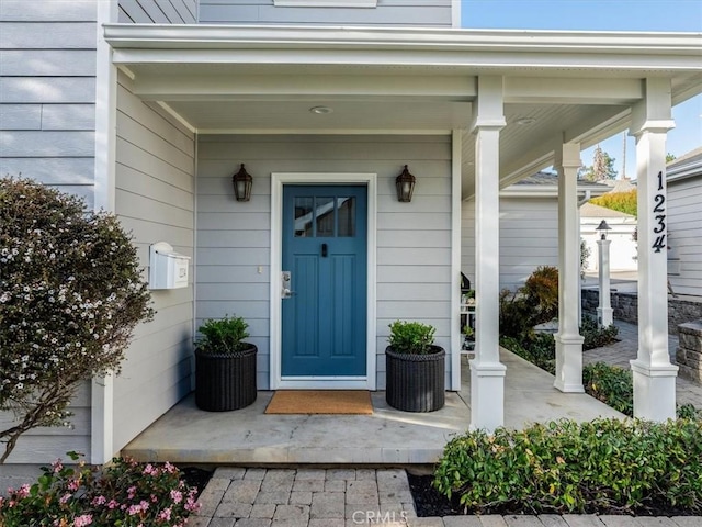 property entrance with covered porch