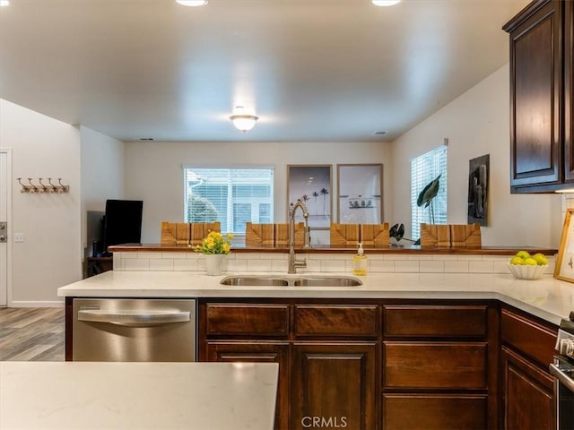 kitchen featuring dark brown cabinetry, plenty of natural light, appliances with stainless steel finishes, and a sink