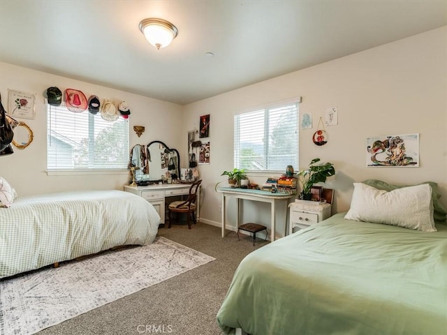 bedroom with carpet floors, multiple windows, and baseboards