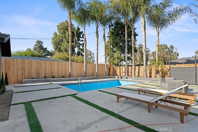 view of swimming pool with a patio area, a fenced backyard, and a fenced in pool