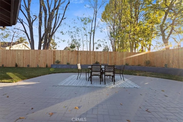 view of patio with outdoor dining space and a fenced backyard