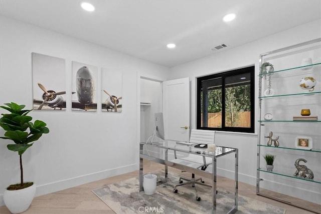 office space with recessed lighting, visible vents, baseboards, and wood finished floors