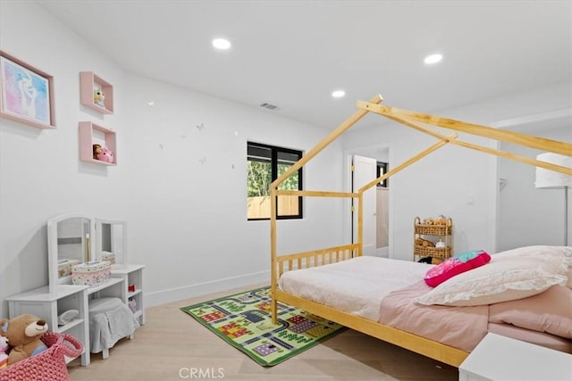 bedroom with baseboards, wood finished floors, visible vents, and recessed lighting