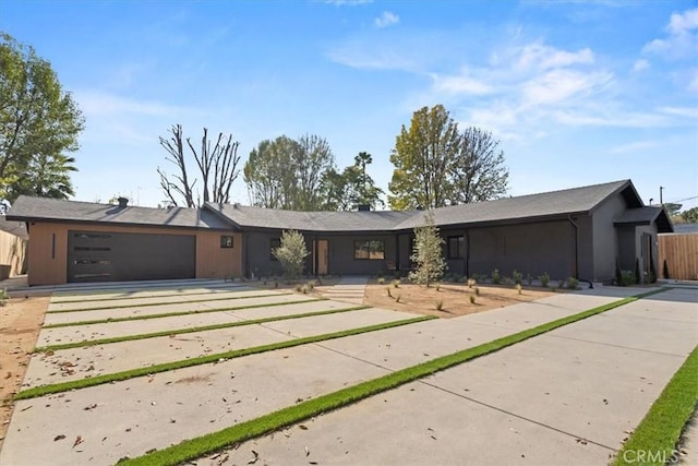 view of front of property featuring a garage and concrete driveway