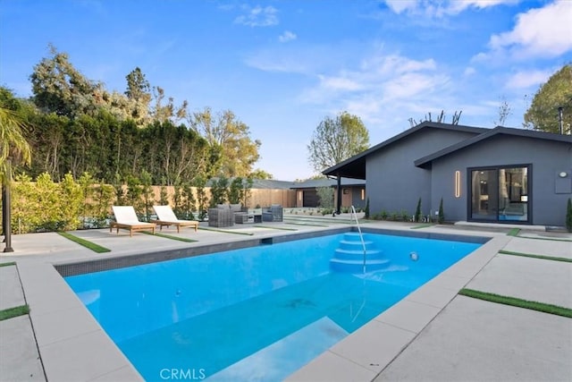 view of pool with fence, an outdoor living space, a fenced in pool, and a patio