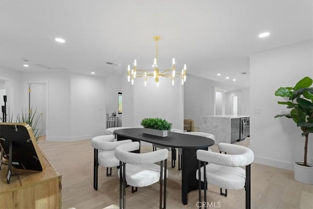 dining area featuring light wood finished floors, baseboards, visible vents, a notable chandelier, and recessed lighting