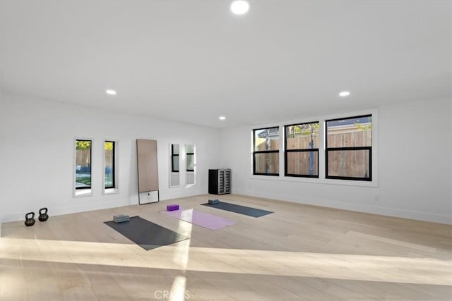 exercise area with recessed lighting, wood finished floors, and a healthy amount of sunlight