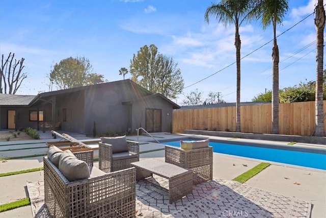 view of swimming pool with a fenced in pool, a patio area, fence, and an outdoor living space