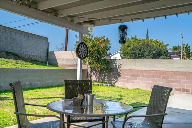 view of patio with fence and outdoor dining area