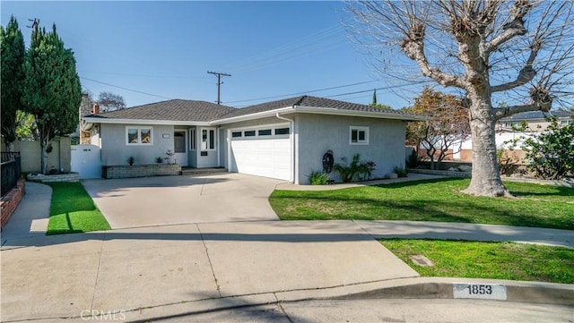 single story home featuring an attached garage, fence, concrete driveway, stucco siding, and a front yard