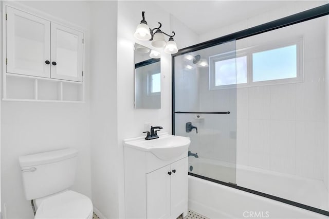 full bath with combined bath / shower with glass door, vanity, and toilet