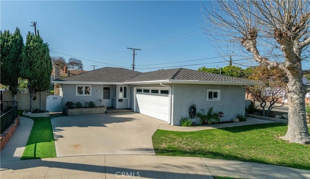 ranch-style house featuring a garage, fence, concrete driveway, stucco siding, and a front lawn