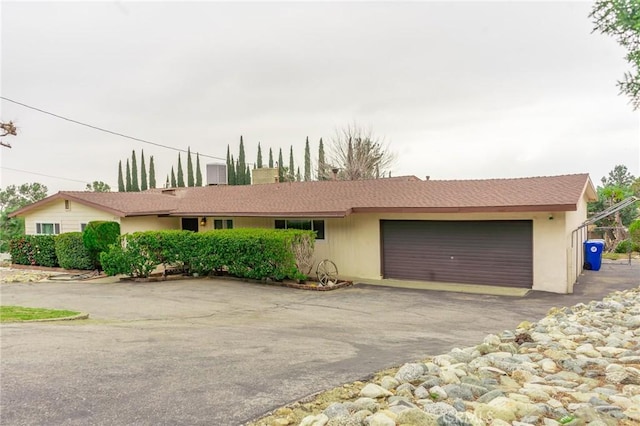 ranch-style house featuring driveway and a garage