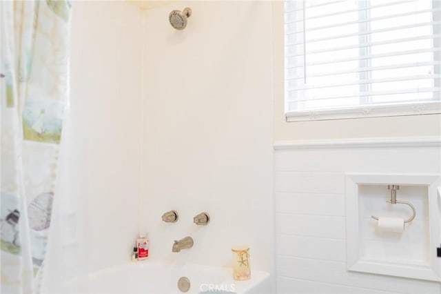 room details featuring shower / bath combination with curtain