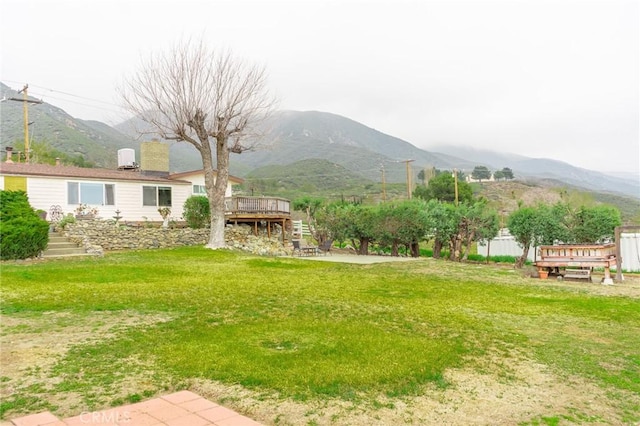 view of yard featuring a deck with mountain view