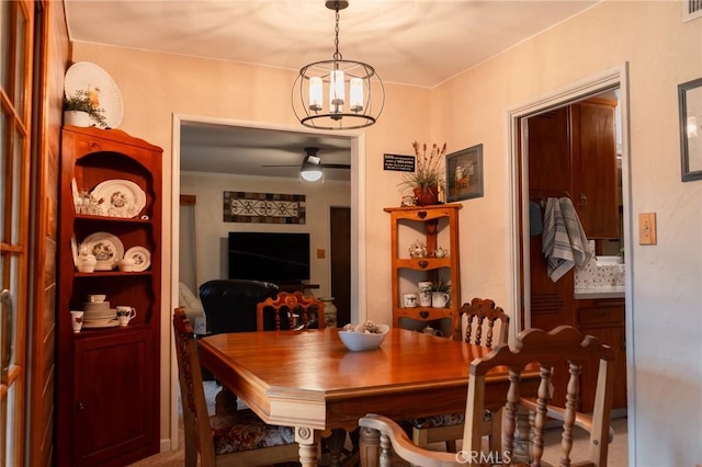 dining room with ceiling fan with notable chandelier