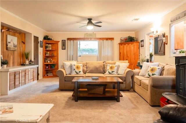 living area with light carpet, a ceiling fan, and crown molding