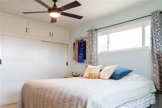 bedroom featuring ceiling fan and a closet