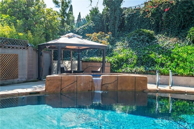 outdoor pool featuring fence and a gazebo