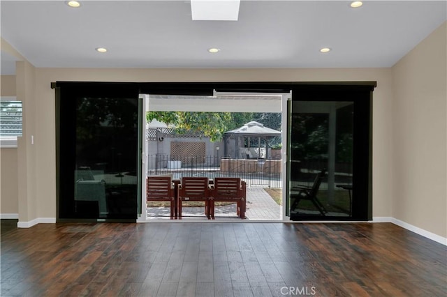 entryway with baseboards, wood finished floors, and recessed lighting