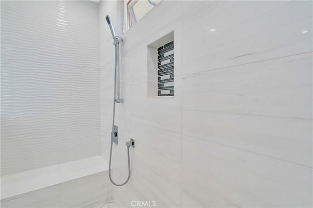 interior space featuring a tile shower