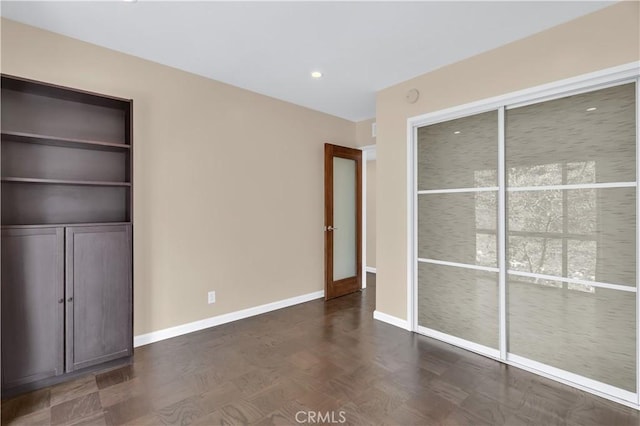 unfurnished bedroom with recessed lighting and baseboards