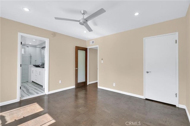 unfurnished bedroom with baseboards, visible vents, connected bathroom, and recessed lighting