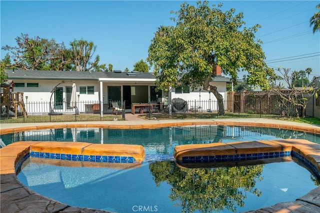 view of swimming pool featuring a patio area, fence, and a fenced in pool