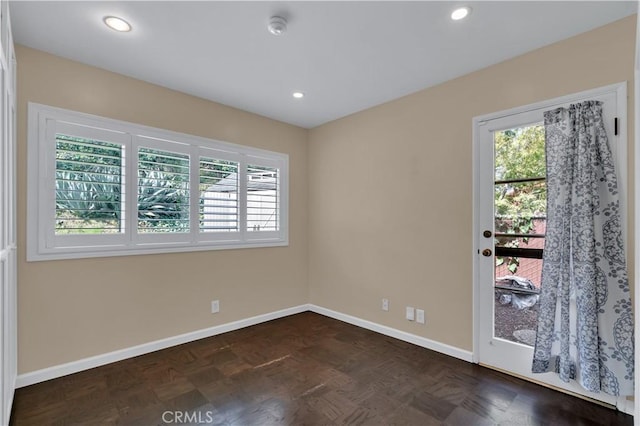 empty room with baseboards and recessed lighting