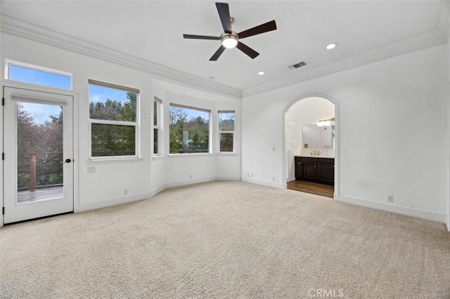 interior space with carpet floors, arched walkways, visible vents, access to outside, and baseboards