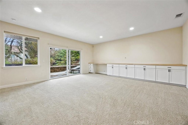 carpeted empty room with recessed lighting, visible vents, and baseboards