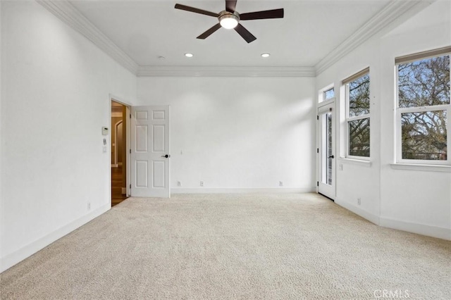 carpeted empty room with recessed lighting, crown molding, and baseboards