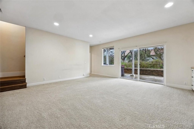 unfurnished living room featuring carpet, visible vents, baseboards, and recessed lighting