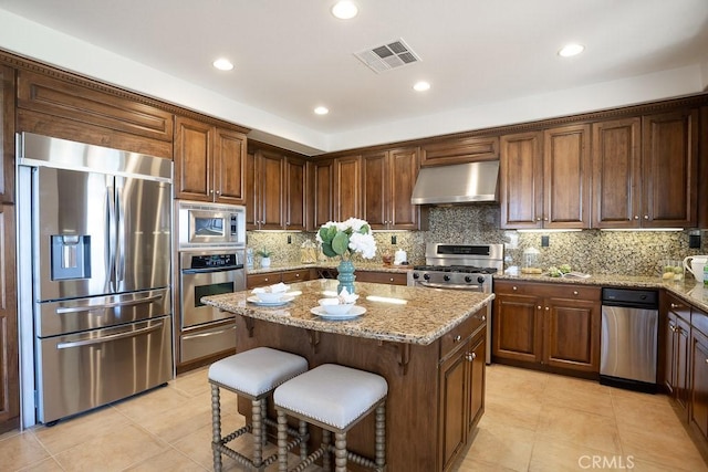 25663 Elmwood Ln, Valencia, CA 91381 - kitchen with visible vents, appliances with stainless steel finishes, light tile patterned floors, and extractor fan