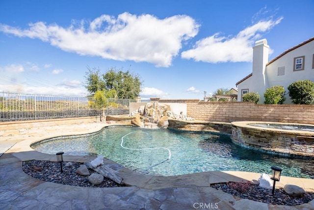 view of pool with an in ground hot tub, a fenced backyard, and a fenced in pool