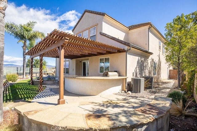 25663 Elmwood Ln, Valencia, CA 91381 - back of property featuring a patio, stucco siding, a pergola, central AC, and fence