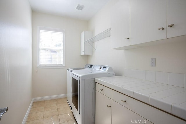 25663 Elmwood Ln, Valencia, CA 91381 - washroom with light tile patterned floors, visible vents, baseboards, cabinet space, and washer and clothes dryer
