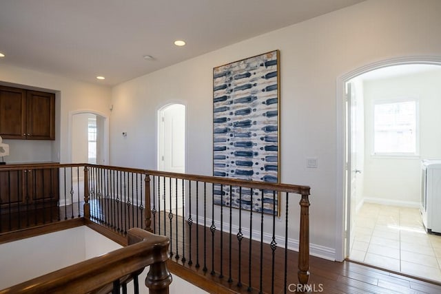 25663 Elmwood Ln, Valencia, CA 91381 - corridor featuring baseboards, arched walkways, an upstairs landing, recessed lighting, and wood finished floors