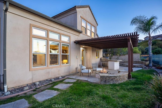 25663 Elmwood Ln, Valencia, CA 91381 - rear view of property featuring a fire pit, a pergola, fence, a patio, and stucco siding