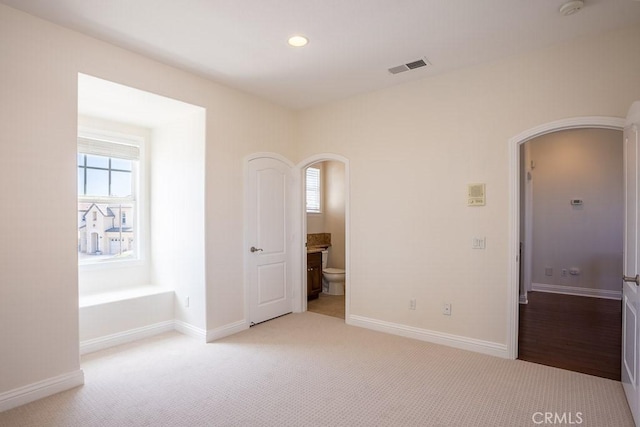 25663 Elmwood Ln, Valencia, CA 91381 - unfurnished bedroom featuring visible vents, recessed lighting, arched walkways, and light carpet