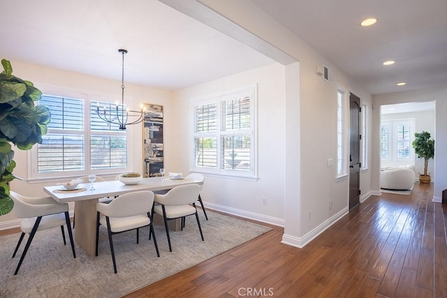 dining room featuring recessed lighting, visible vents, an inviting chandelier, wood finished floors, and baseboards