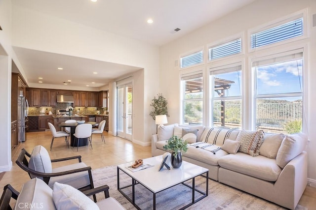 living area with baseboards, light tile patterned floors, visible vents, and recessed lighting