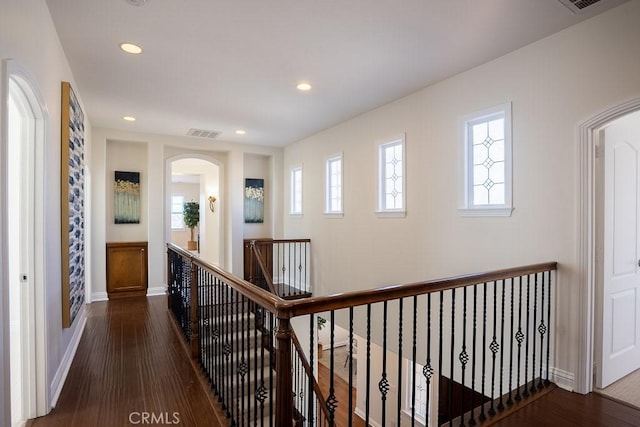 hall with baseboards, visible vents, wood finished floors, an upstairs landing, and recessed lighting