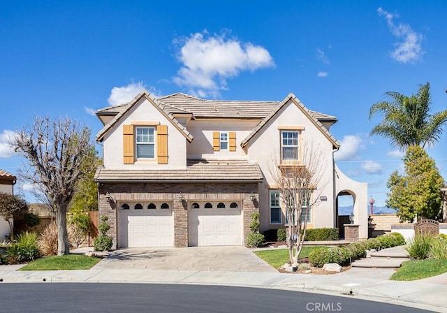 25663 Elmwood Ln, Valencia, CA 91381 - view of front of house featuring a tiled roof, an attached garage, stucco siding, and concrete driveway