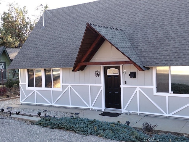 exterior space featuring a shingled roof and board and batten siding