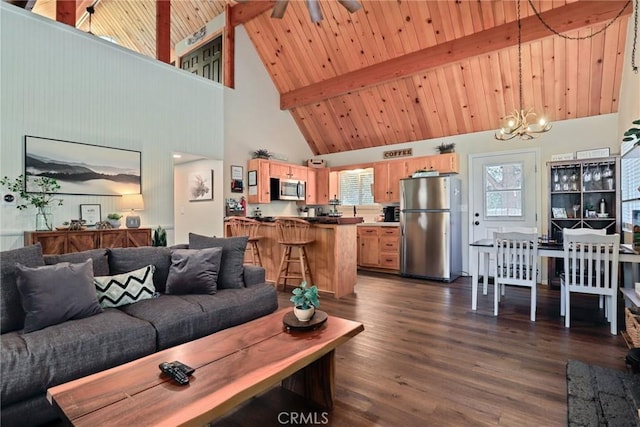 living room with vaulted ceiling with beams, wood ceiling, dark wood finished floors, and ceiling fan with notable chandelier