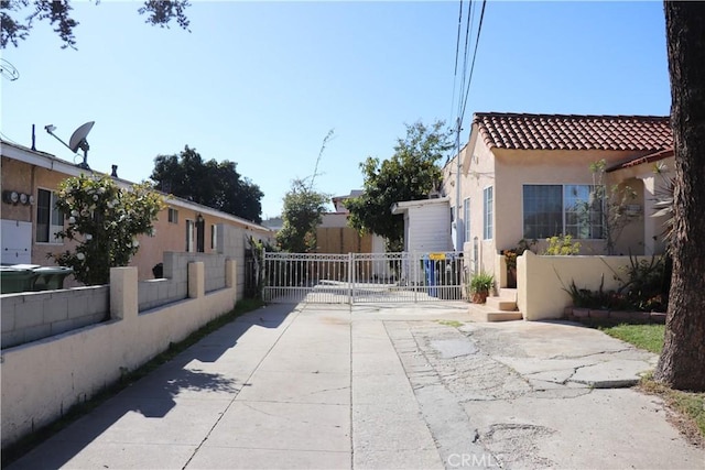 view of street featuring a gate, driveway, and a gated entry