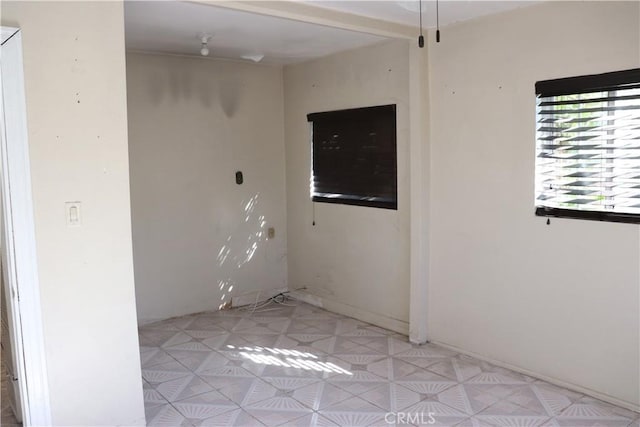 spare room featuring light floors